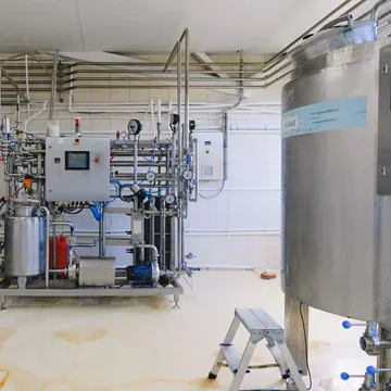 Industrial tanks and processing machinery inside a factory